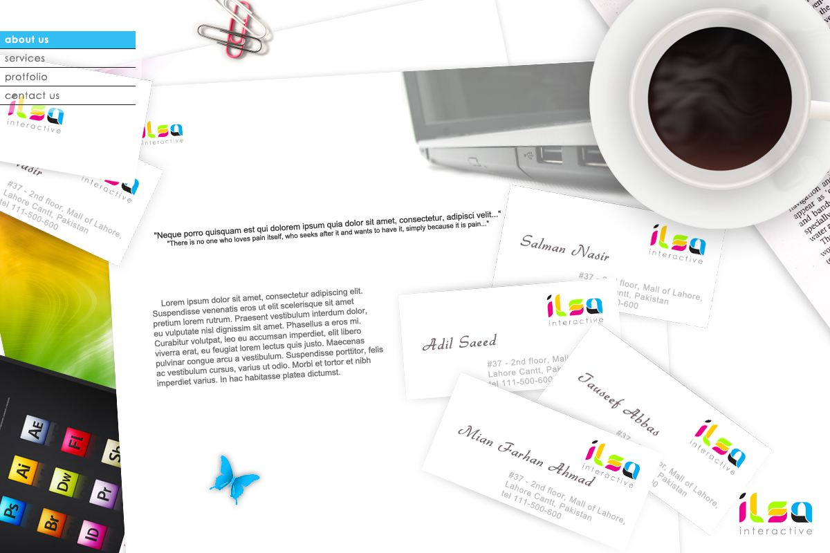 A white desk scattered with ILSA Interactive business cards for Salman Nasir, Adil Saeed, Tauseef Abbas and Mian Farhan Ahmad, beside a laptop, a cup of coffee and a tablet showing Adobe app icons.